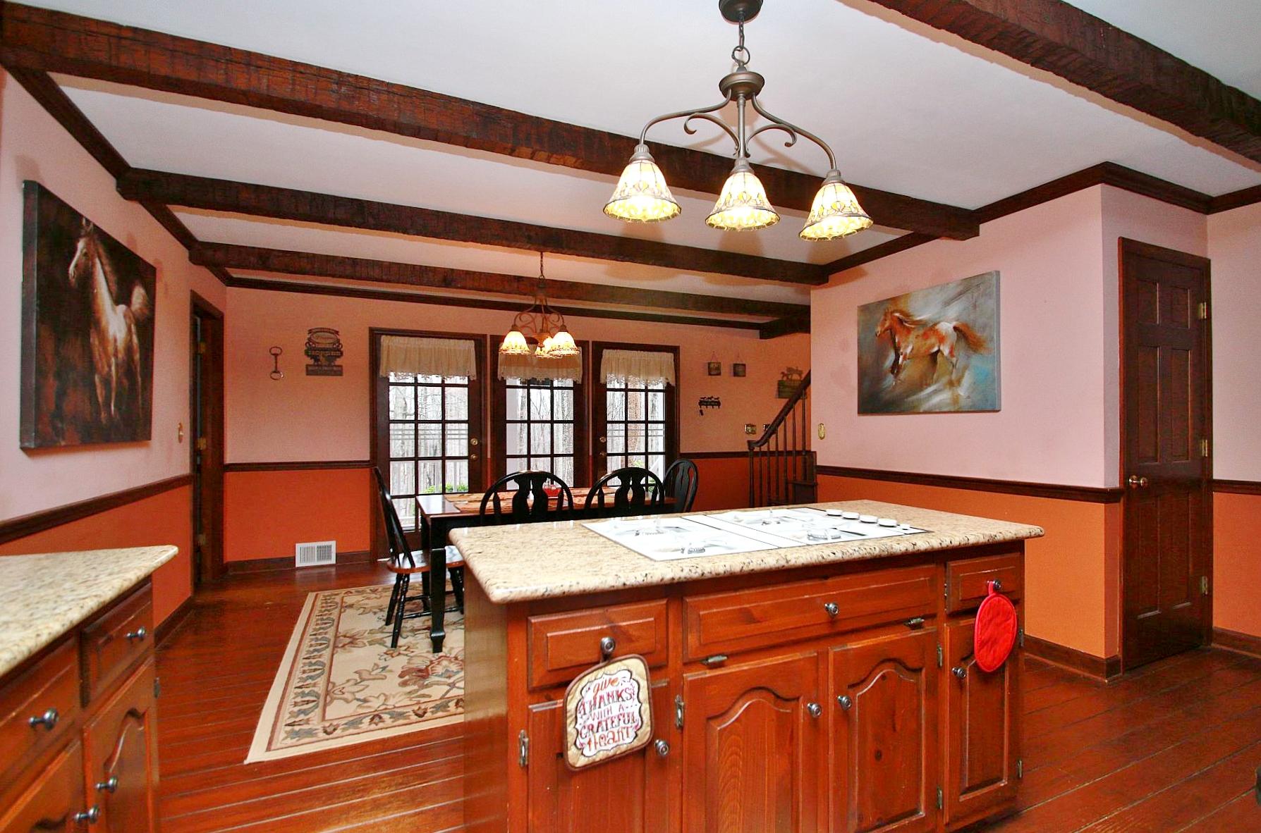 392 Morgans Fork Road Penhook, VA 24137 - Photo 43 of 56 a view of a dining room with furniture a chandelier and wooden floor