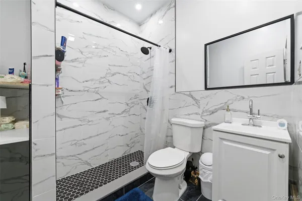 a bathroom with a sink toilet and shower