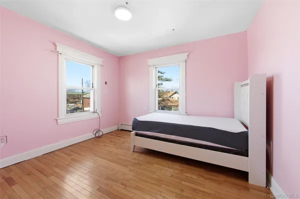 a spacious bedroom with a bed and a window