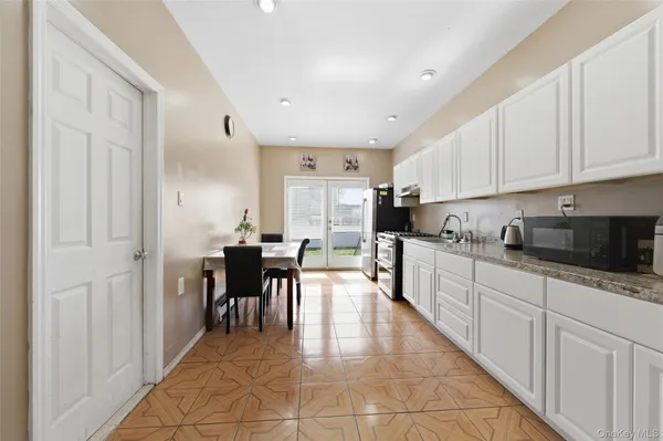 a large white kitchen with lots of counter top space