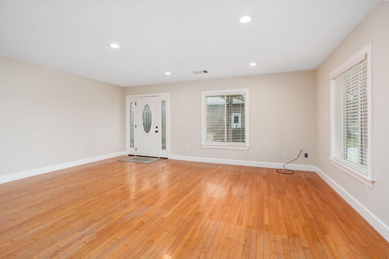 10580 Old Stage Road Porterville, CA 93257 - Photo 12 of 73 an empty room with wooden floor and windows