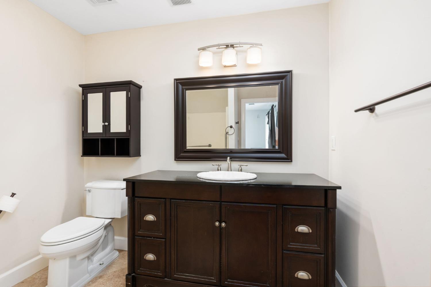 10580 Old Stage Road Porterville, CA 93257 - Photo 25 of 73 a bathroom with a toilet sink and mirror