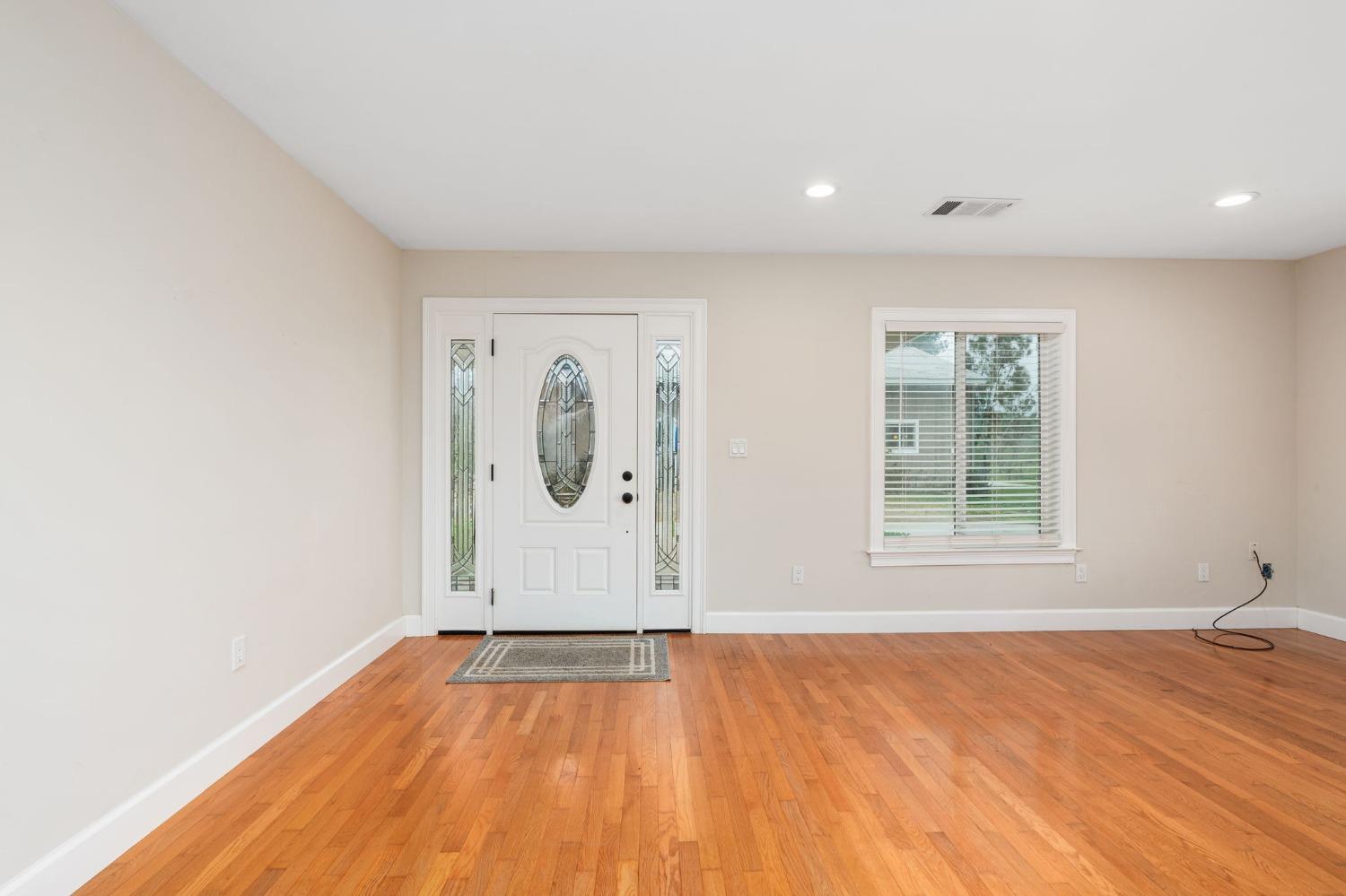 10580 Old Stage Road Porterville, CA 93257 - Photo 10 of 73 an empty room with window and wooden floor