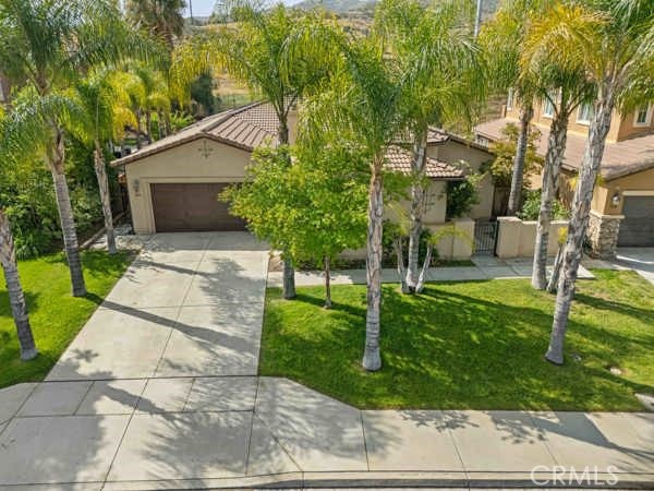341 Caldera Street Perris, CA 92570 - Photo 16 of 53 a front view of a house with a yard