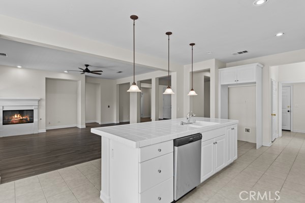 341 Caldera Street Perris, CA 92570 - Photo 20 of 53 a hall with a sink a large mirror and a wooden floors