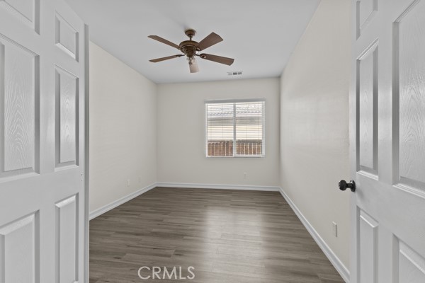 341 Caldera Street Perris, CA 92570 - Photo 23 of 53 a view of empty room with wooden floor and fan