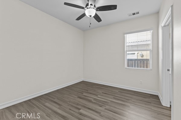 341 Caldera Street Perris, CA 92570 - Photo 24 of 53 wooden floor in an empty room with a window