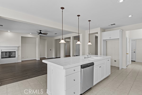 341 Caldera Street Perris, CA 92570 - Photo 35 of 53 a hall with a sink a large mirror and a wooden floors