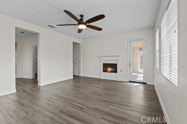 341 Caldera Street Perris, CA 92570 - Photo 39 of 53 a view of a livingroom with wooden floor and a ceiling fan