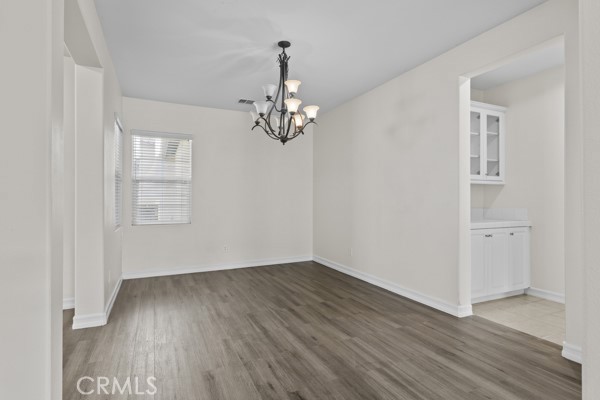 341 Caldera Street Perris, CA 92570 - Photo 45 of 53 wooden floor in an empty room with a window