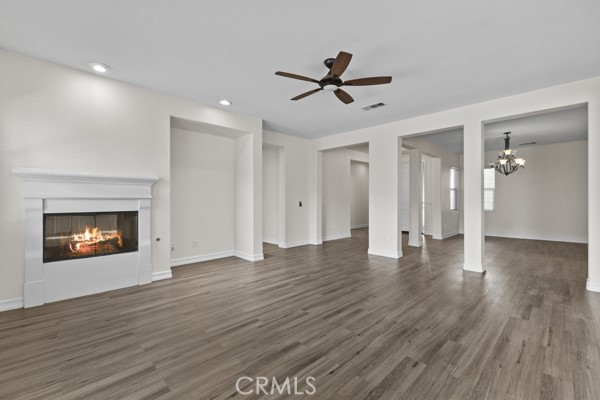 341 Caldera Street Perris, CA 92570 - Photo 50 of 53 a view of a room with wooden floor and a ceiling fan