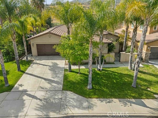 341 Caldera Street Perris, CA 92570 - Photo 9 of 53 a front view of a house with garden