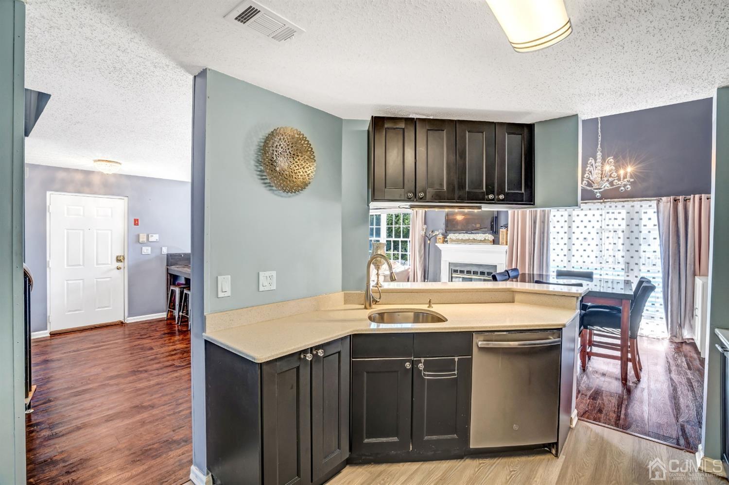 532 Edpas Road New Brunswick, NJ 08901 - Photo 12 of 29 a kitchen with kitchen island granite countertop a stove a sink and a refrigerator with wooden floor