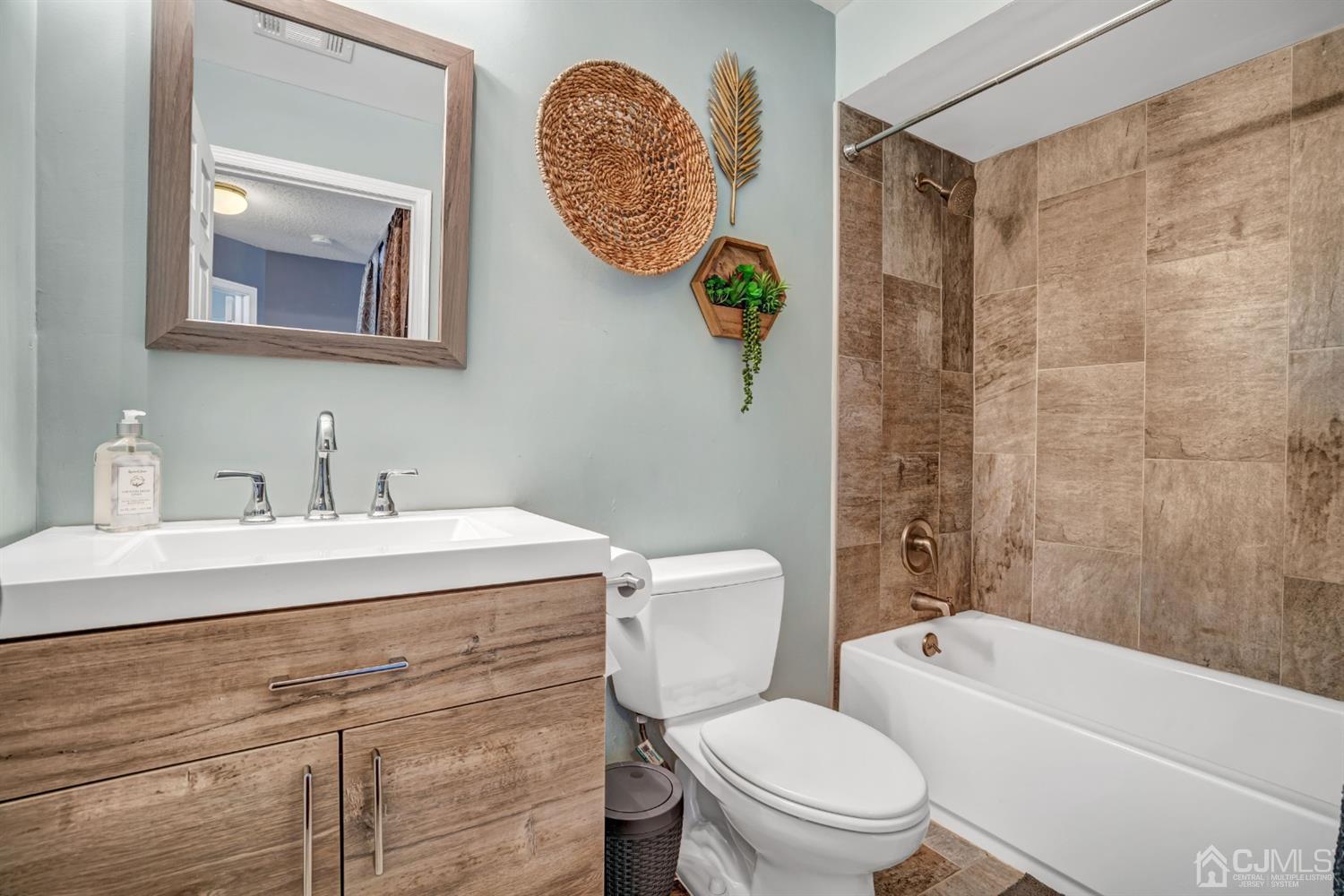 532 Edpas Road New Brunswick, NJ 08901 - Photo 17 of 29 a bathroom with a sink mirror vanity and toilet