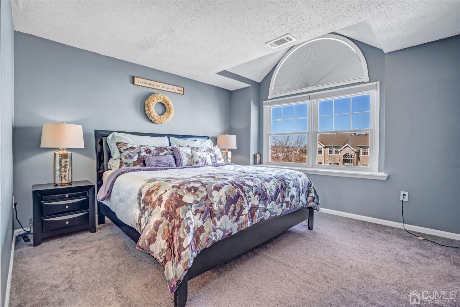 532 Edpas Road New Brunswick, NJ 08901 - Photo 19 of 29 a bed sitting in a bedroom next to a lamp