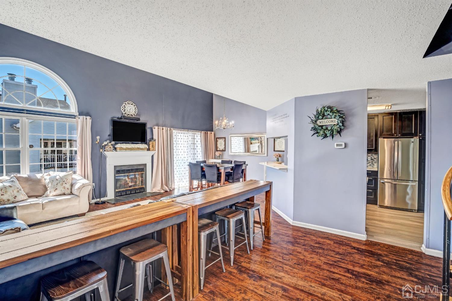 532 Edpas Road New Brunswick, NJ 08901 - Photo 5 of 29 a kitchen with stainless steel appliances granite countertop a refrigerator a stove top oven a dining table and chairs with wooden floor