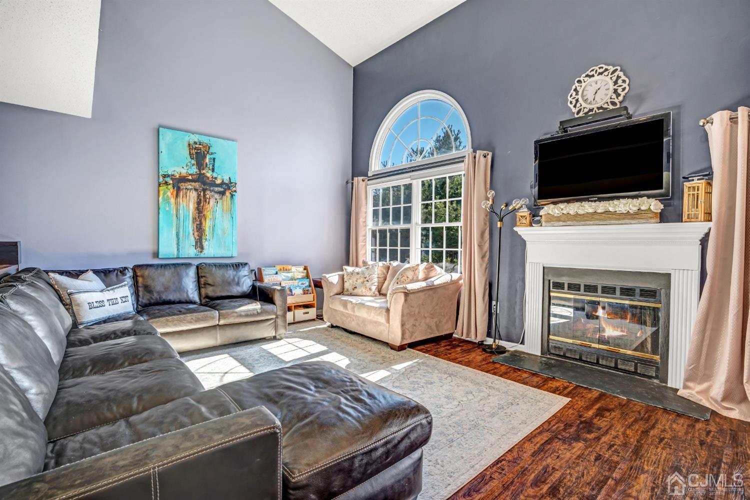 532 Edpas Road New Brunswick, NJ 08901 - Photo 6 of 29 a living room with furniture a flat screen tv and a fireplace