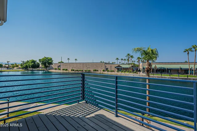 a view of a balcony with wooden floor and fence