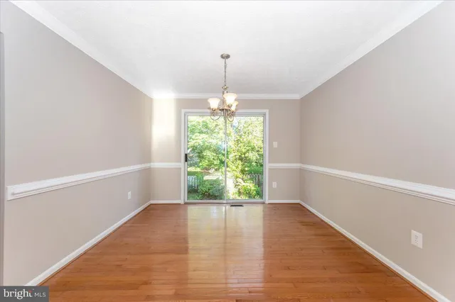 a kitchen with stainless steel appliances and wooden floor