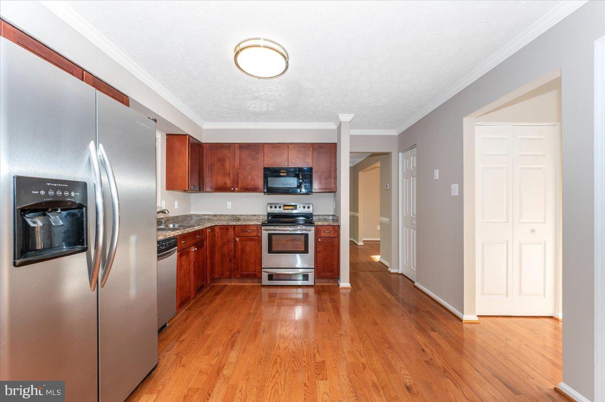 5004 Finch Court Frederick, MD 21703 - Photo 18 of 63 a kitchen with stainless steel appliances a refrigerator and a stove top oven