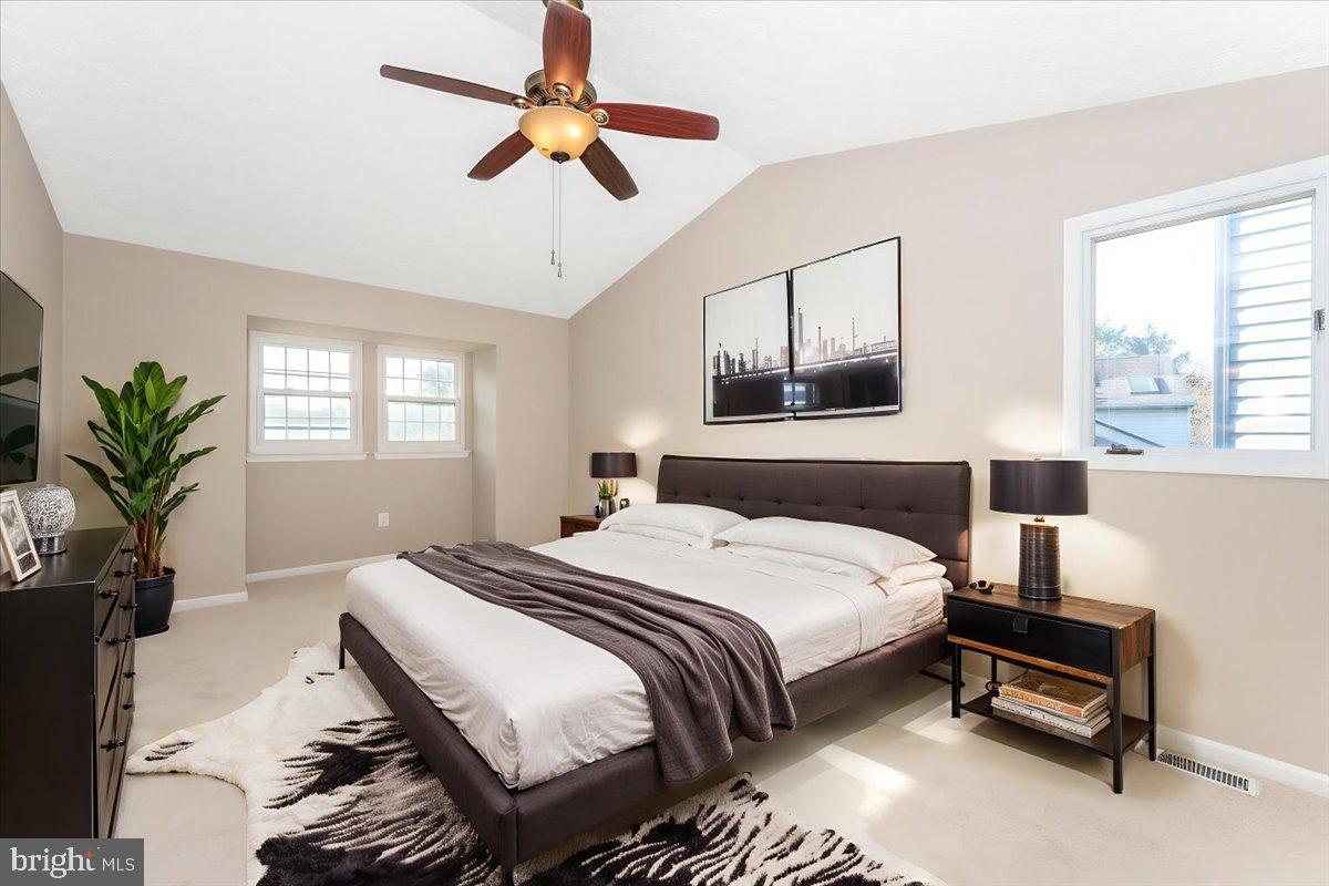 5004 Finch Court Frederick, MD 21703 - Photo 26 of 63 a bedroom with a bed a dresser and potted plant