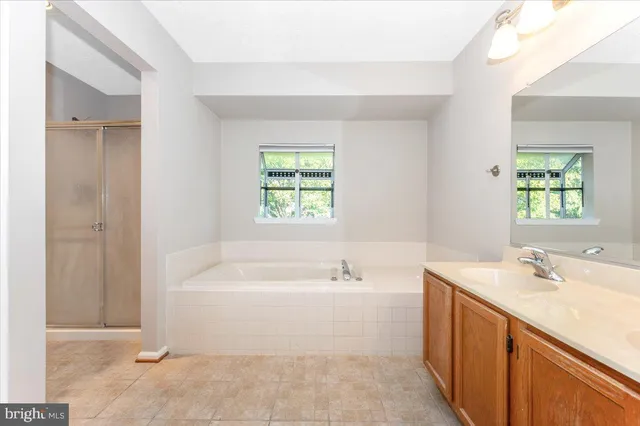 an empty room with a ceiling fan and a window