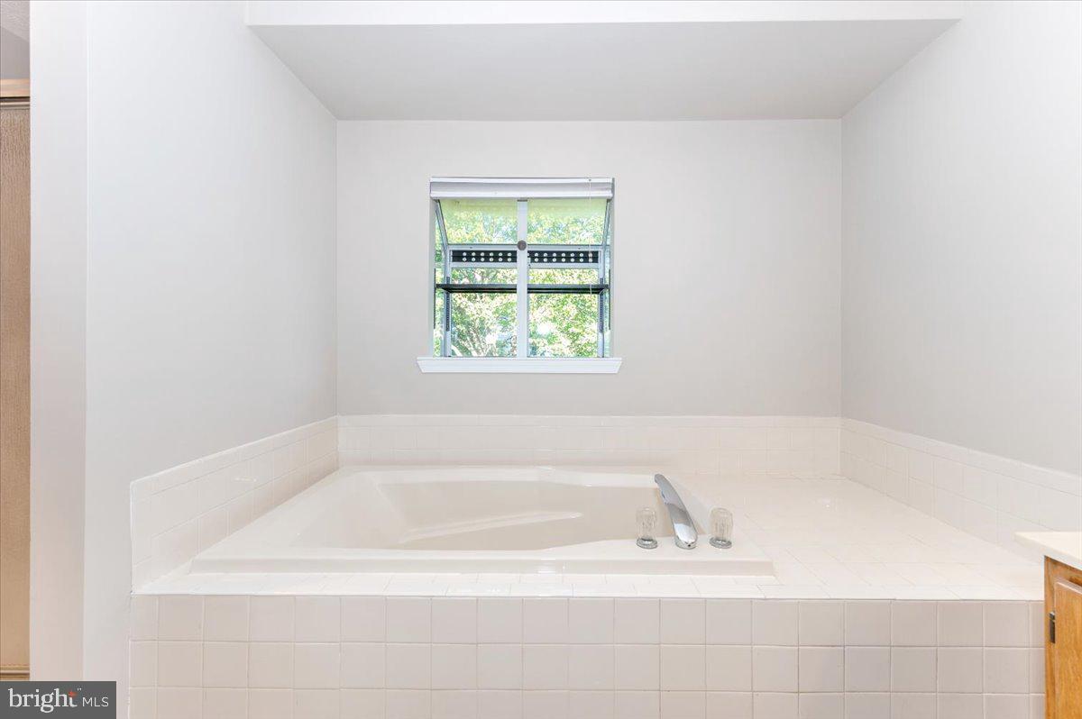 5004 Finch Court Frederick, MD 21703 - Photo 33 of 63 a white bath tub sitting in a bathroom next to a window