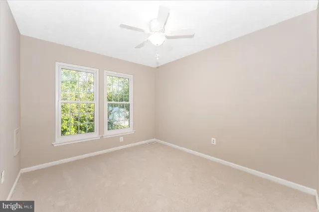 a view of a house with a wooden deck and a yard