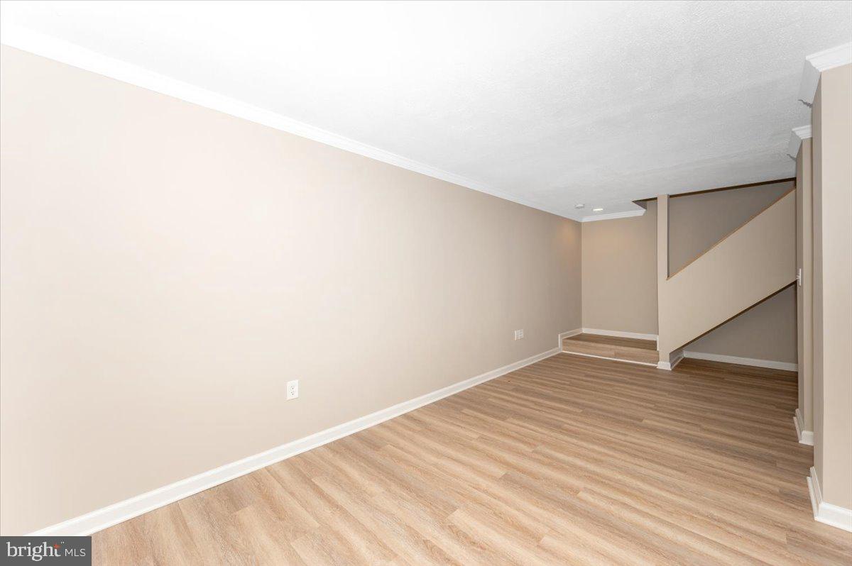 5004 Finch Court Frederick, MD 21703 - Photo 43 of 63 a view of an empty room with wooden floor