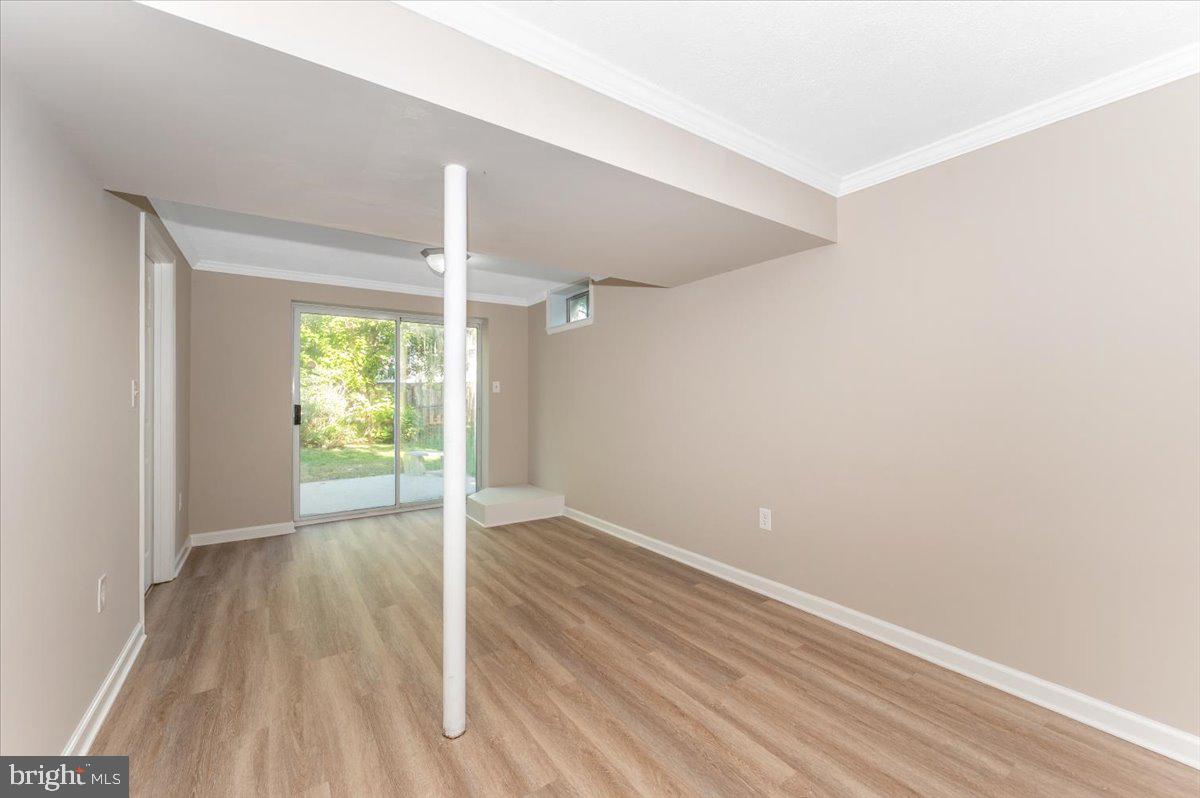 5004 Finch Court Frederick, MD 21703 - Photo 44 of 63 a view of an empty room with wooden floor and a window