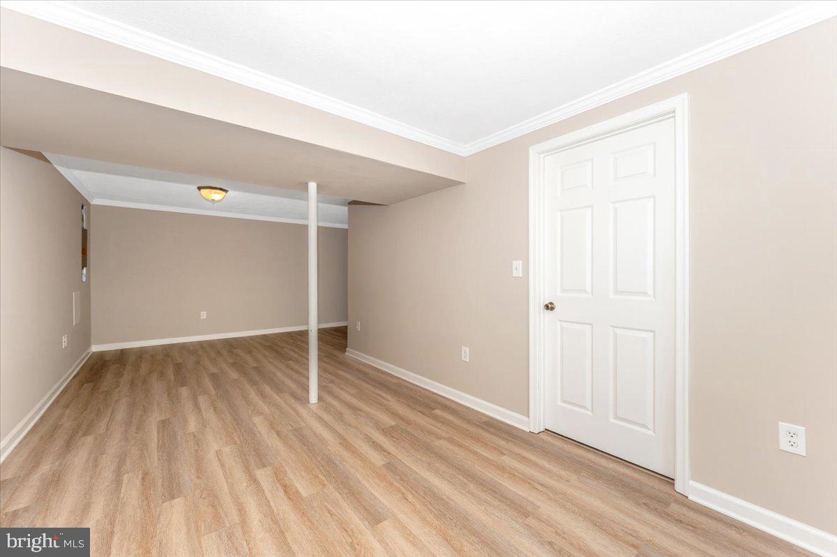 5004 Finch Court Frederick, MD 21703 - Photo 45 of 63 an empty room with wooden floor and windows
