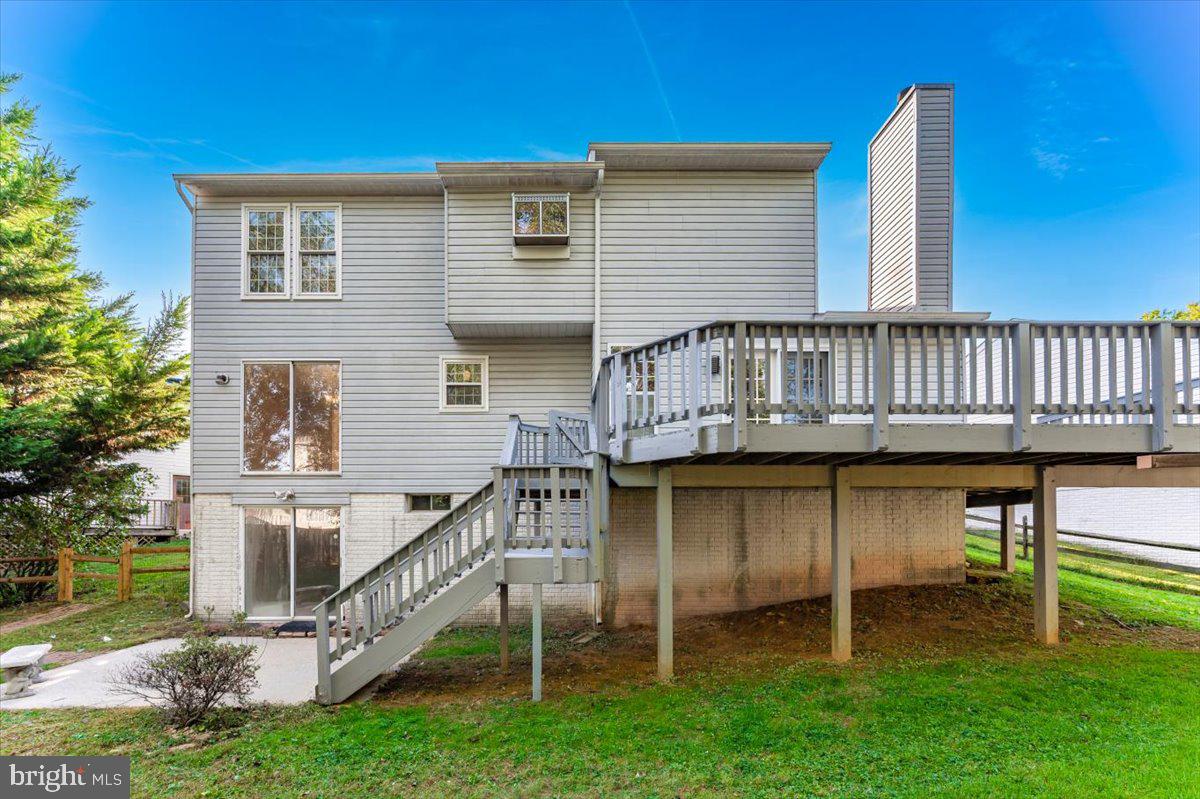 5004 Finch Court Frederick, MD 21703 - Photo 47 of 63 a view of a house with a wooden deck and a yard