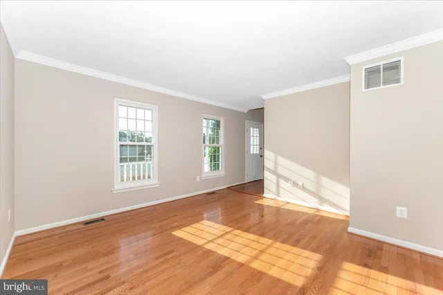 a view of a room with window wooden floor and chandelier