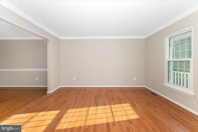 a view of room with window and hardwood floor