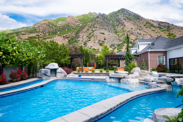 1263 Chapman Court Alpine, UT 84004 - Photo 5 of 83 Swimming pool featuring a patio area, a pergola, a jacuzzi, and a mountain view