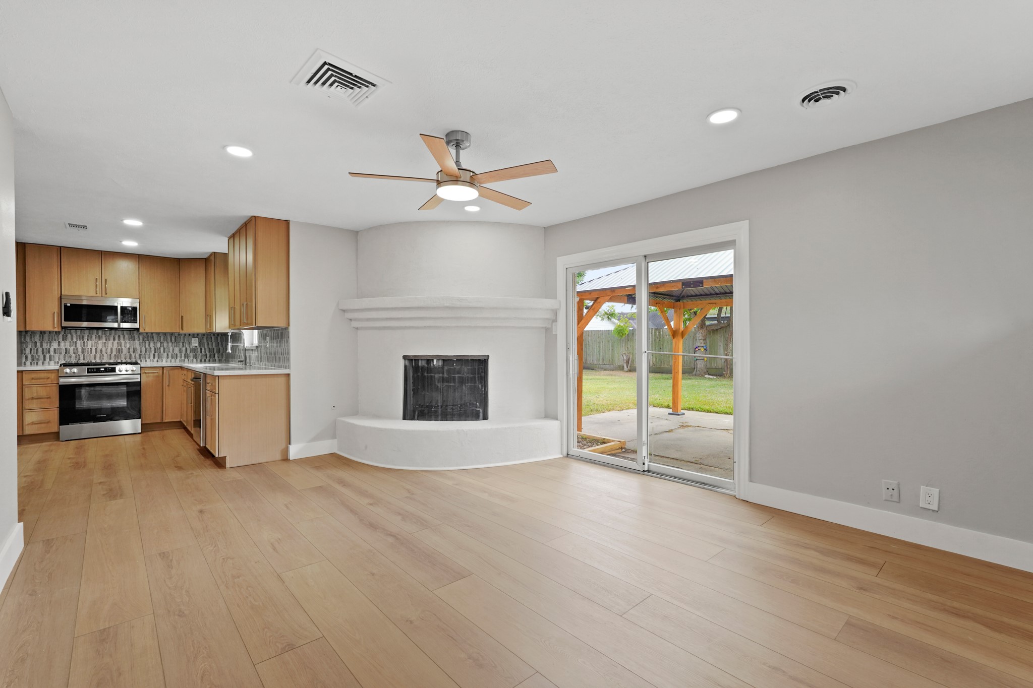 5451 Redstart Street Houston, TX 77096 - Photo 12 of 23 a view of a kitchen with a sink and a fireplace