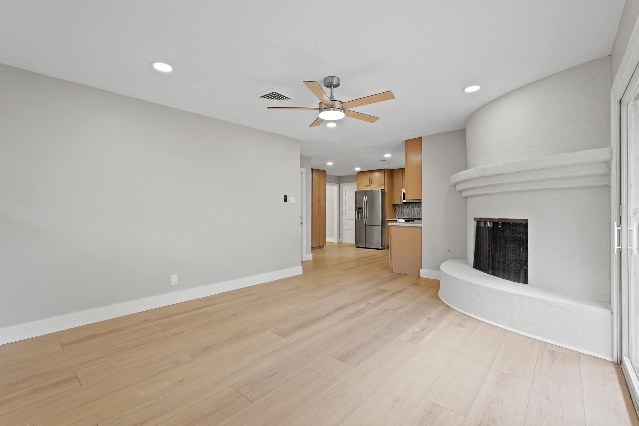 5451 Redstart Street Houston, TX 77096 - Photo 13 of 23 an empty room with a fireplace and fan