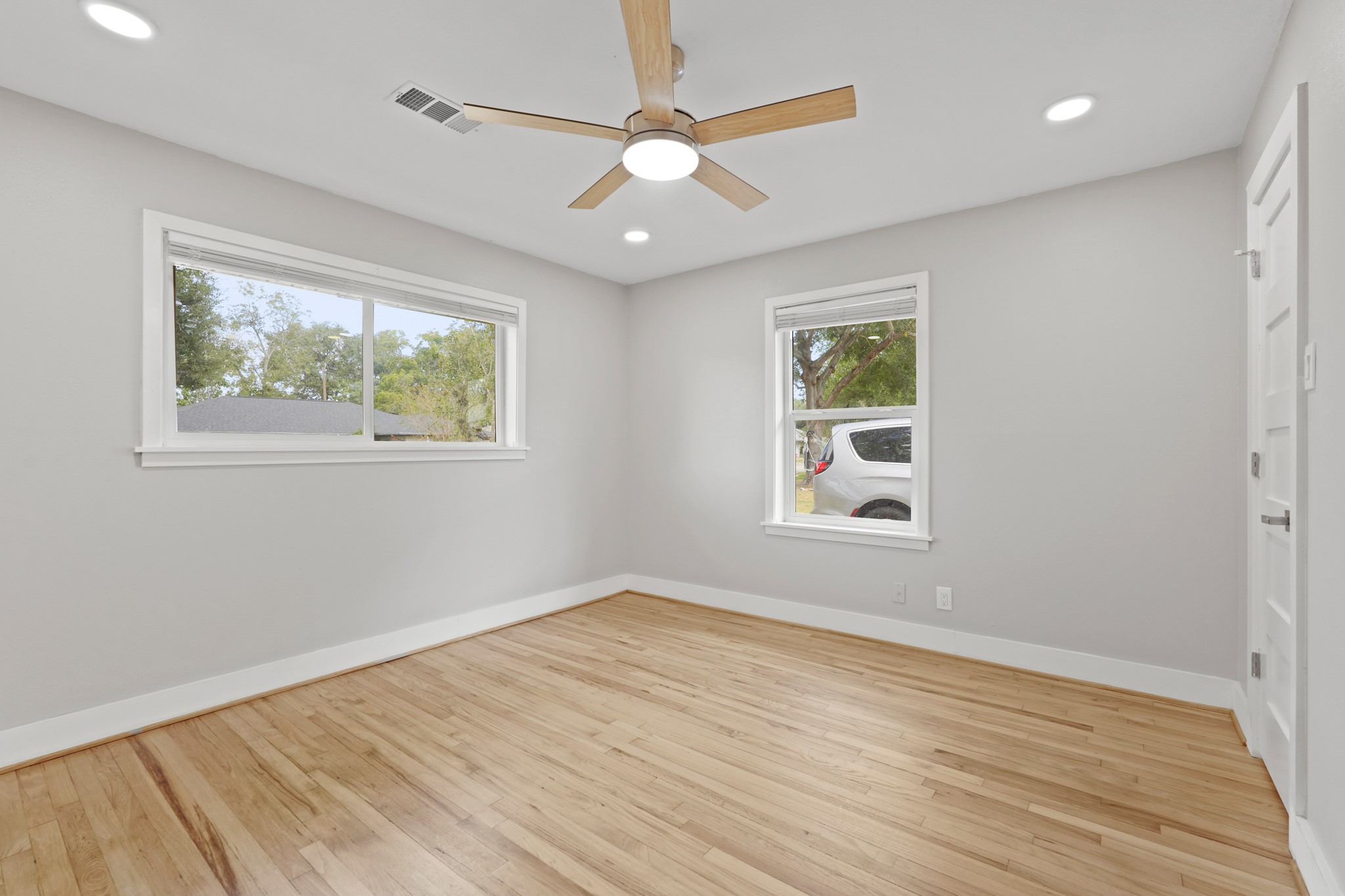 5451 Redstart Street Houston, TX 77096 - Photo 14 of 23 a view of an empty room with wooden floor and a window