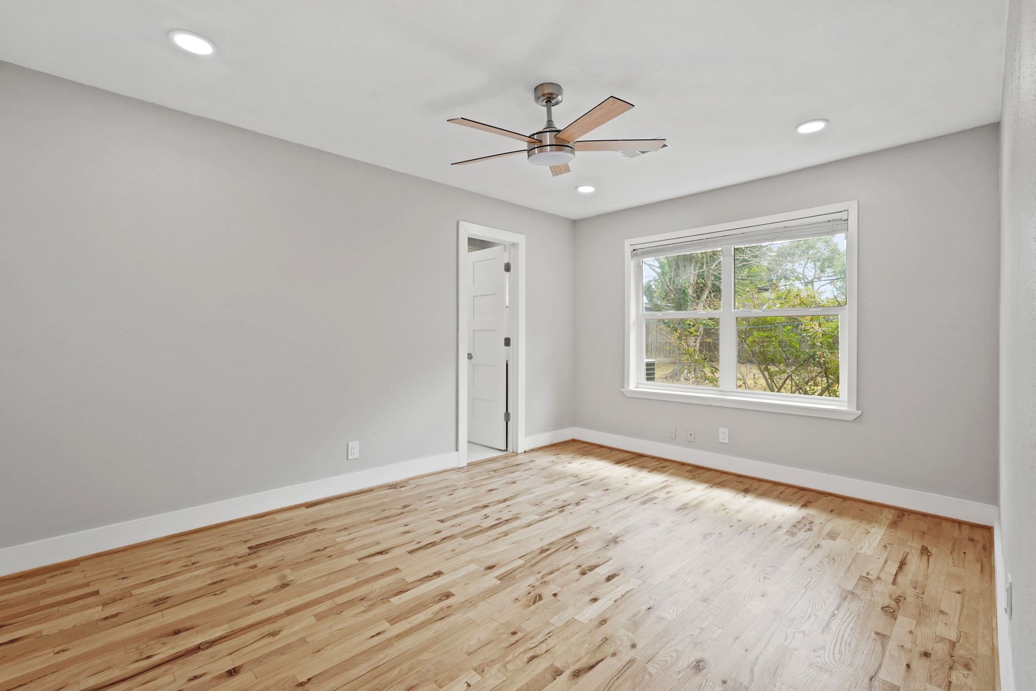 5451 Redstart Street Houston, TX 77096 - Photo 19 of 23 a view of an empty room with wooden floor and a window