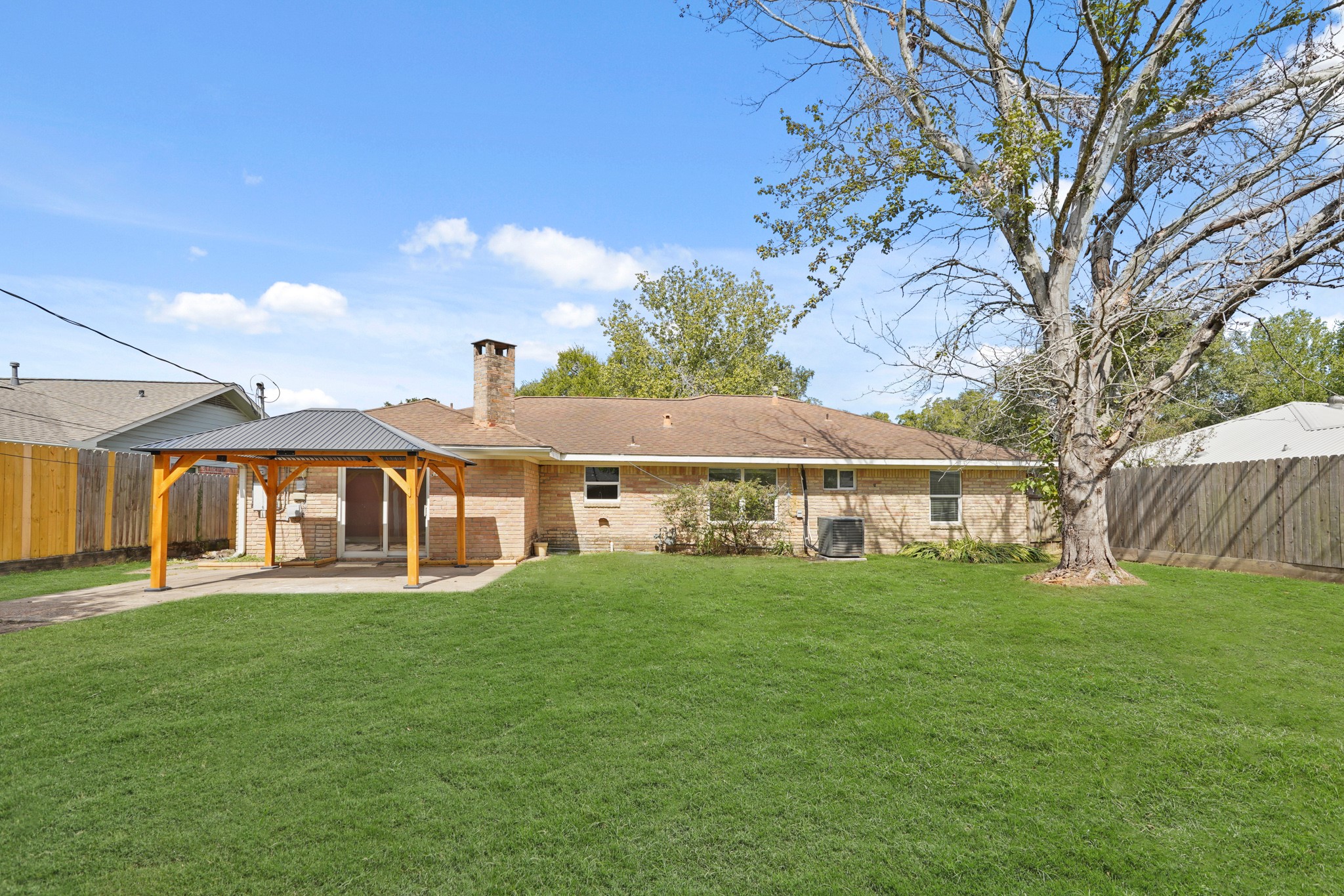 5451 Redstart Street Houston, TX 77096 - Photo 22 of 23 a view of a house with a big yard and large trees