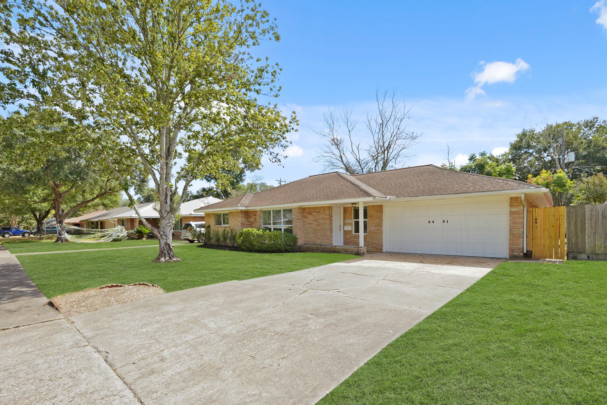 5451 Redstart Street Houston, TX 77096 - Photo 3 of 23 a front view of a house with a yard and garage