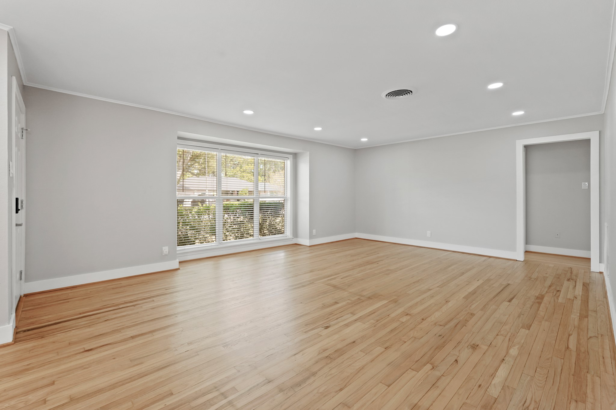 5451 Redstart Street Houston, TX 77096 - Photo 6 of 23 a view of an empty room with wooden floor and a window