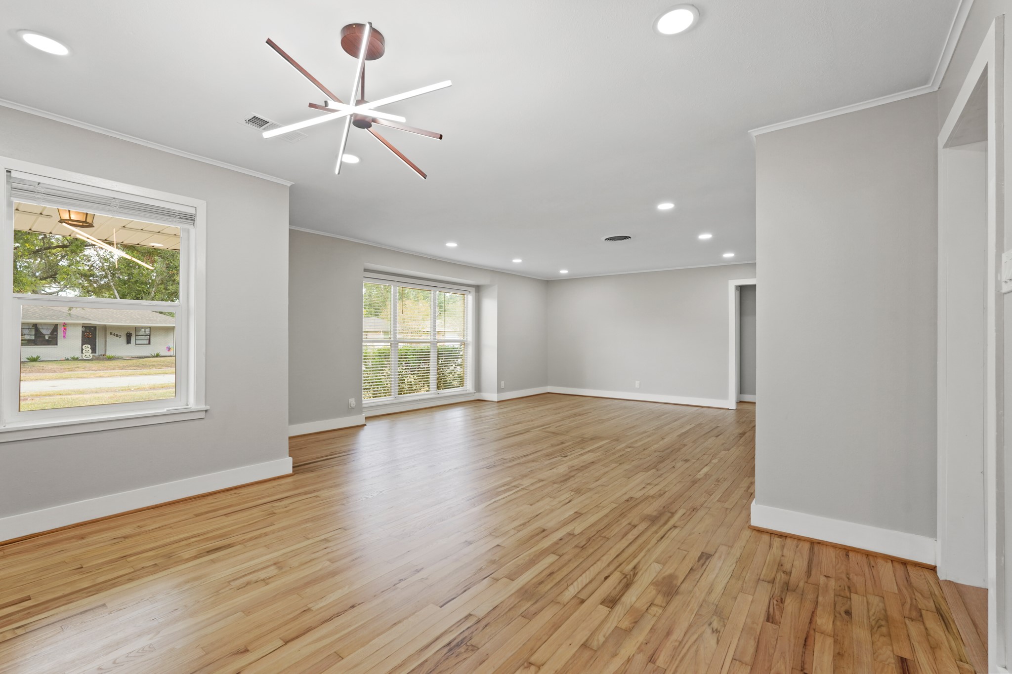 5451 Redstart Street Houston, TX 77096 - Photo 7 of 23 a view of an empty room with wooden floor and a window