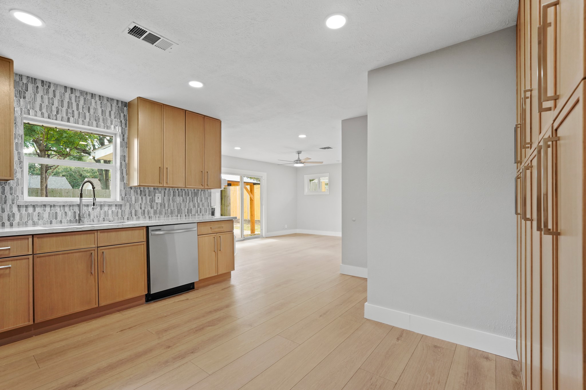 5451 Redstart Street Houston, TX 77096 - Photo 9 of 23 a kitchen with granite countertop a stove a sink and a refrigerator