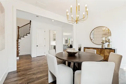 a view of a dining room with furniture and a chandelier
