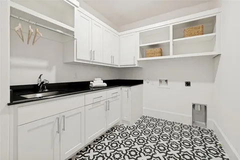 a kitchen with granite countertop white cabinets and sink