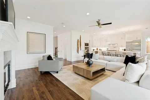 a living room with fireplace furniture and a wooden floor