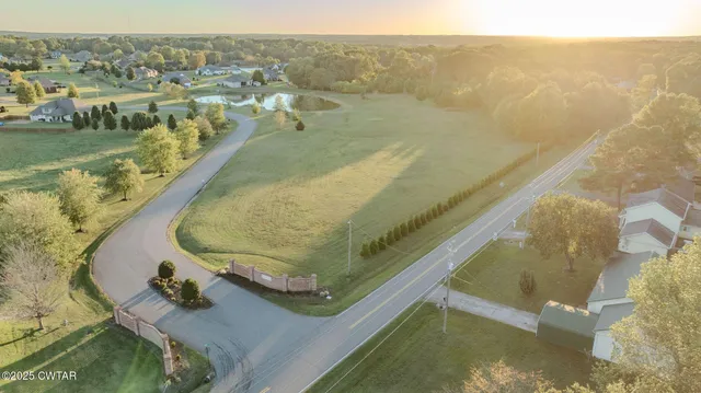 a view of a swimming pool with a yard