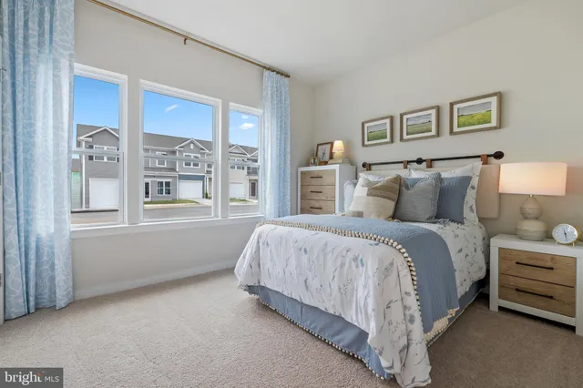 a spacious bedroom with a bed and a window