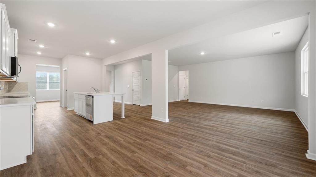 504 Bullock Pass Jefferson, GA 30549 - Photo 12 of 54 a view of a big room with wooden floor and windows